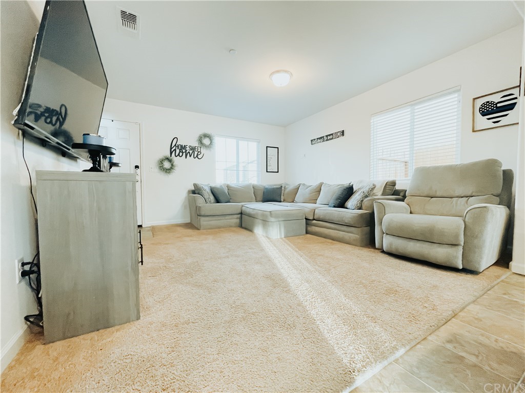 385 Ostrander Avenue Merced, CA 95341 - Photo 3 of 12 a living room with furniture and a flat screen tv