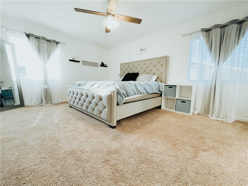 385 Ostrander Avenue Merced, CA 95341 - Photo 6 of 12 a bedroom with a bed lamp and a fireplace