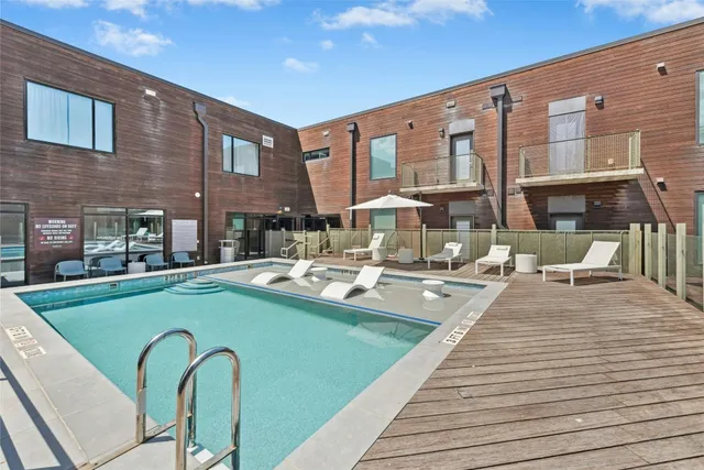 a view of a house with swimming pool and sitting area