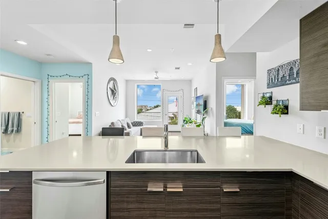 a kitchen with counter top space a sink and appliances