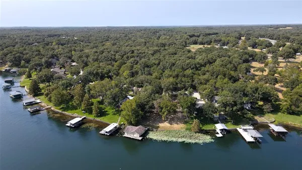 an aerial view of a houses with yard