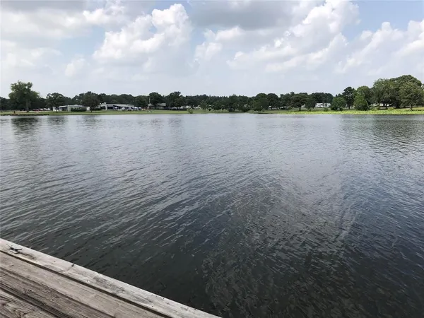 a view of a lake with houses in the back