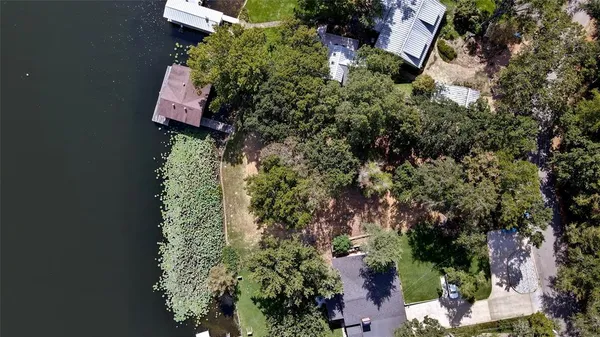 an aerial view of a house with a yard