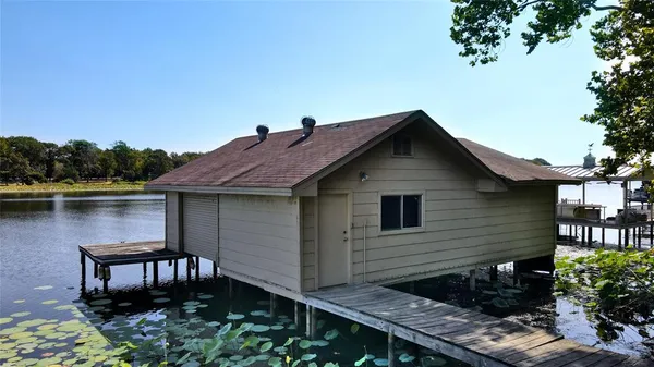 a backyard of a house with lake view and a potted plant