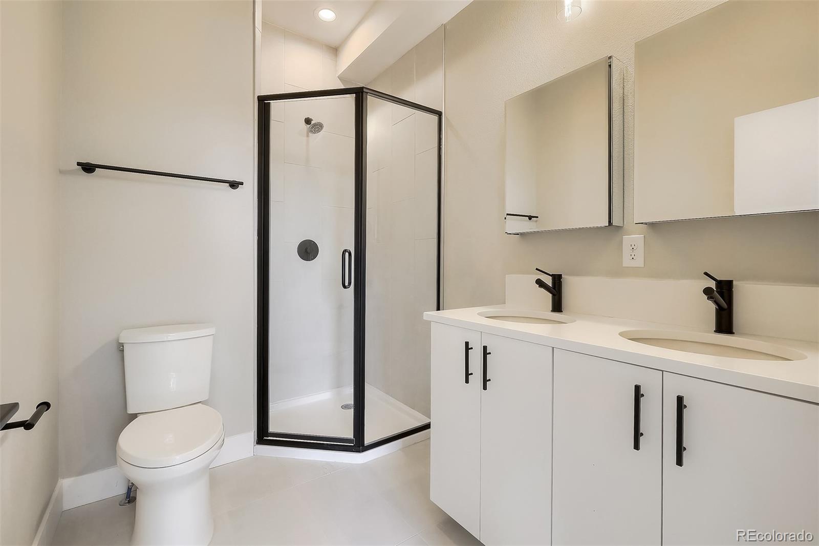 3820 Jason Street, Unit 6 Denver, CO 80211 - Photo 13 of 31 a bathroom with a shower a sink a toilet and a mirror