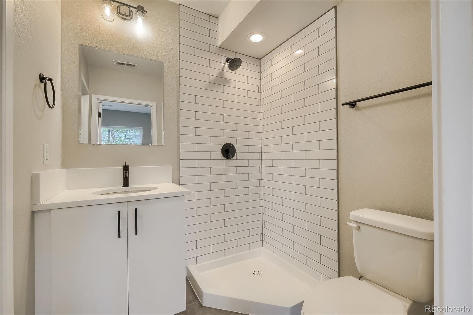 3820 Jason Street, Unit 6 Denver, CO 80211 - Photo 21 of 31 a bathroom with a sink a toilet and shower