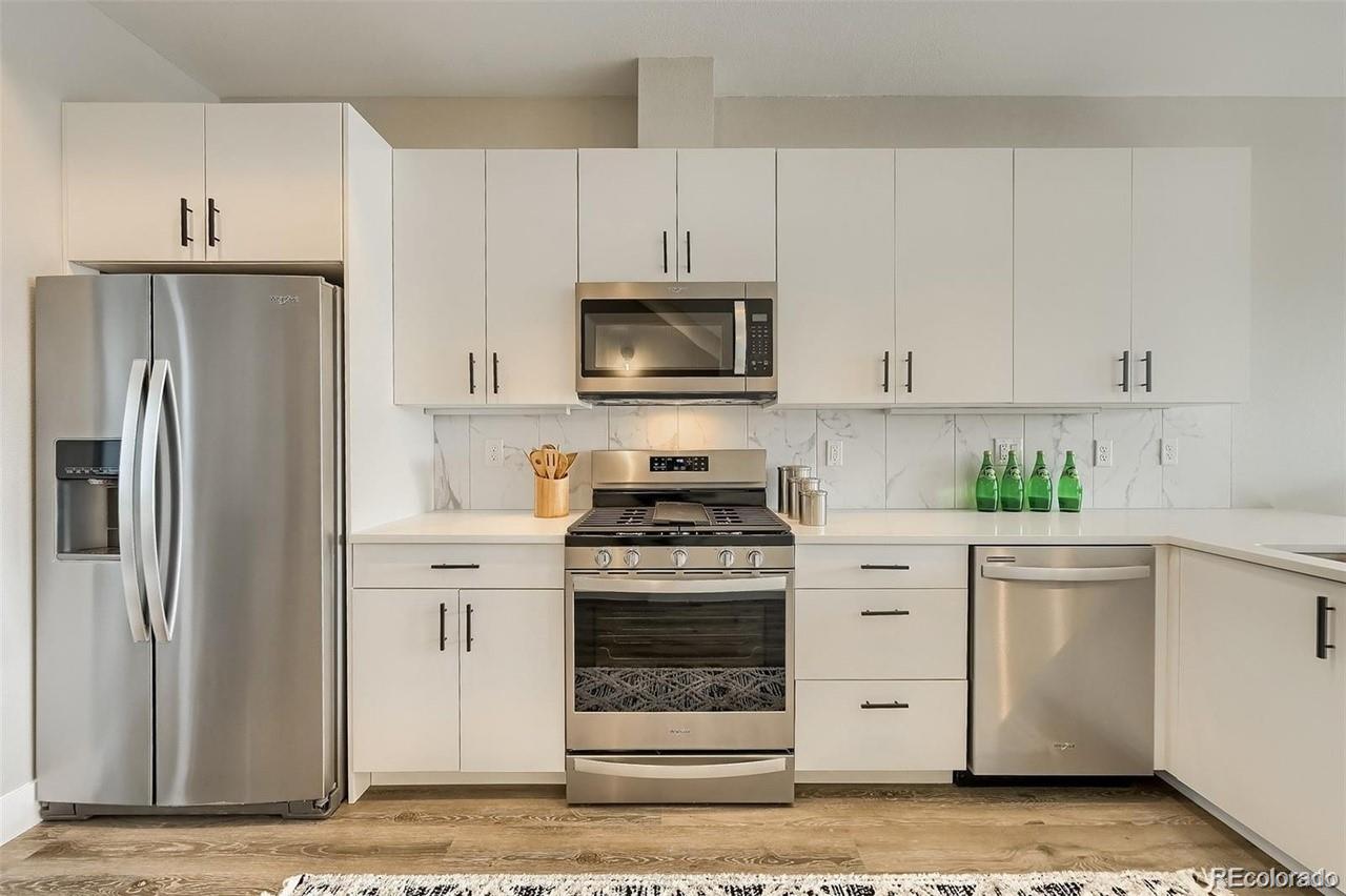 3820 Jason Street, Unit 6 Denver, CO 80211 - Photo 4 of 31 a kitchen with white cabinets and stainless steel appliances