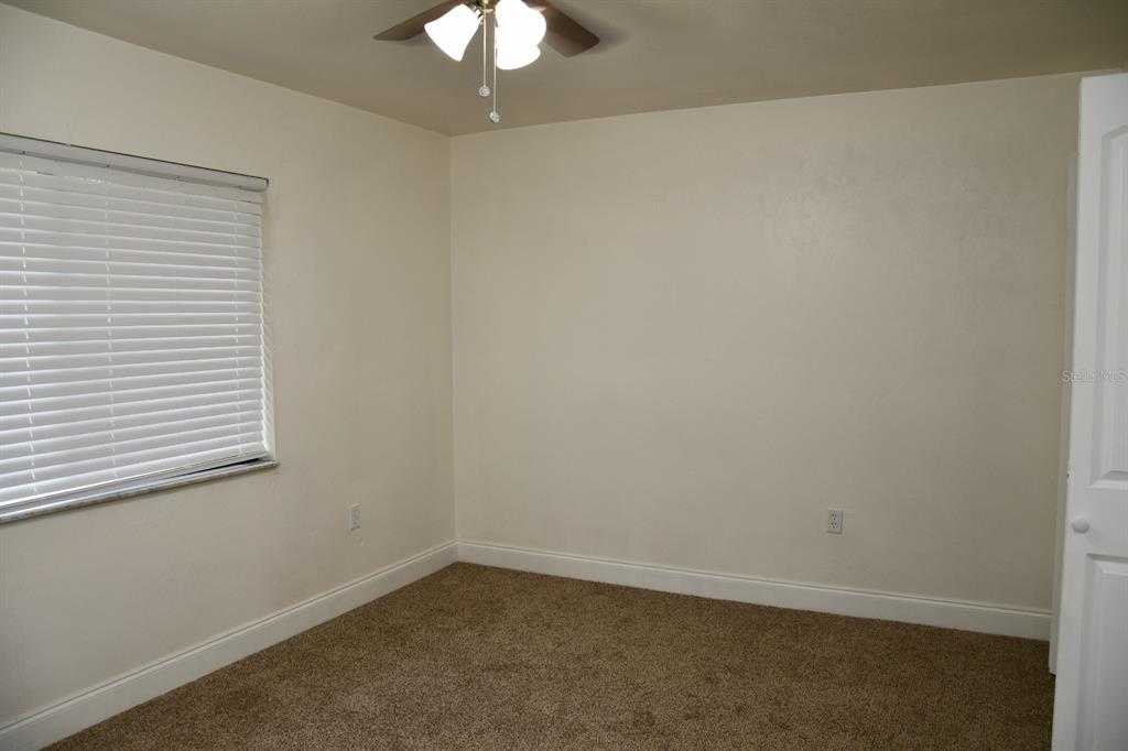 2635 Southwest 35th Place, Unit 1302 Gainesville, FL 32608 - Photo 14 of 17 an empty room with a chandelier fan