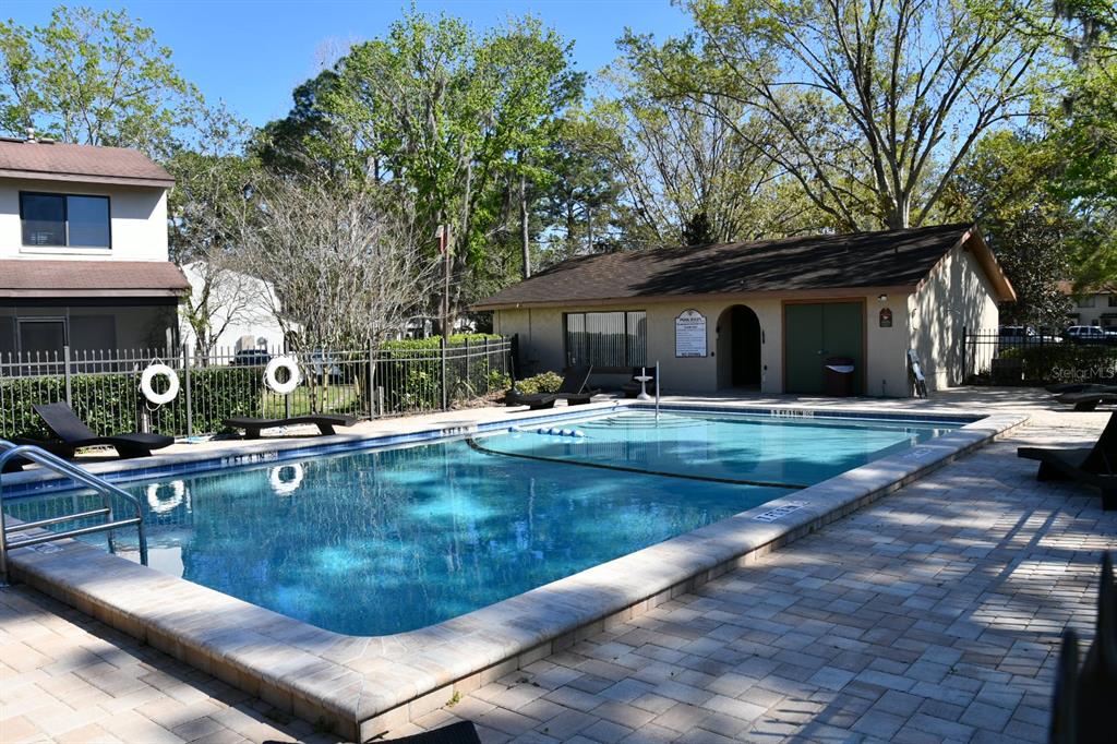 2635 Southwest 35th Place, Unit 1302 Gainesville, FL 32608 - Photo 17 of 17 a view of a house with swimming pool and sitting area