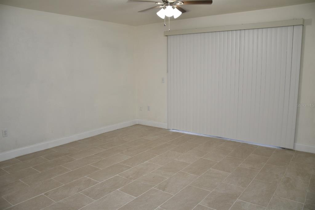 2635 Southwest 35th Place, Unit 1302 Gainesville, FL 32608 - Photo 7 of 17 an empty room with a chandelier fan