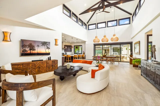 a living room with furniture and a chandelier
