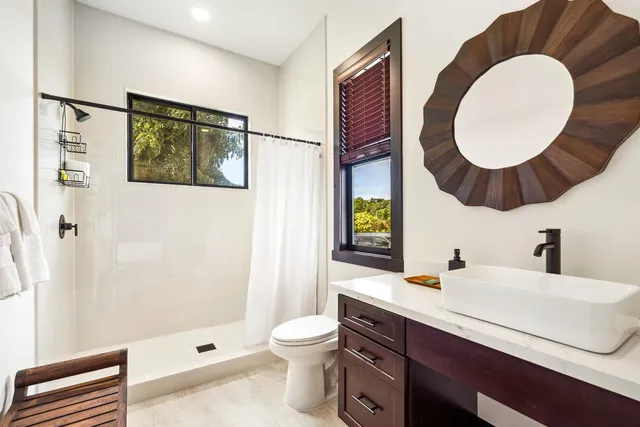 a bathroom with a sink mirror vanity and toilet