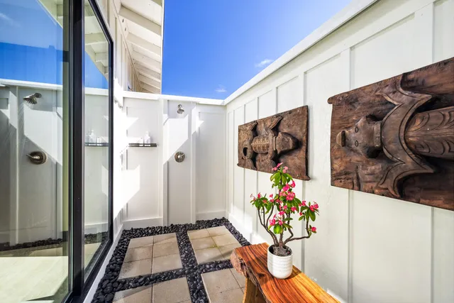 a bathroom with a sink mirror and a shower