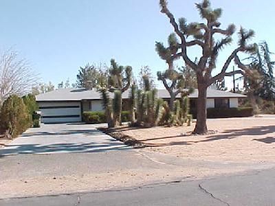 14223 Flathead Road Apple Valley, CA 92307 - Photo 1 of 1 a house with trees in front of it