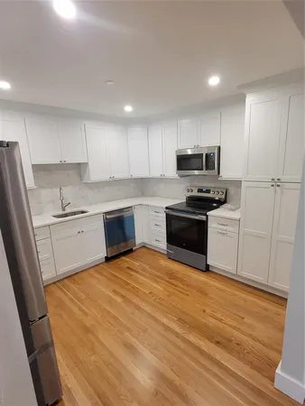 a kitchen with a stove a sink and a refrigerator