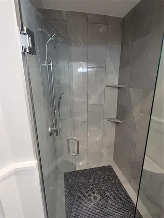 a bathroom with a glass door shower