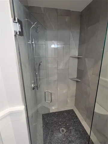a bathroom with a glass door shower