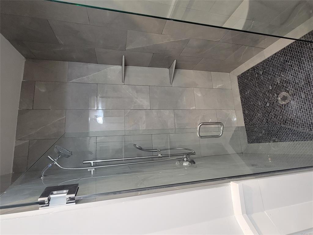 731 Broadway, Unit 4 Valhalla, NY 10595 - Photo 12 of 25 a bathroom with a glass door shower