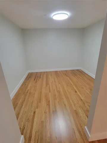 an empty room with wooden floor