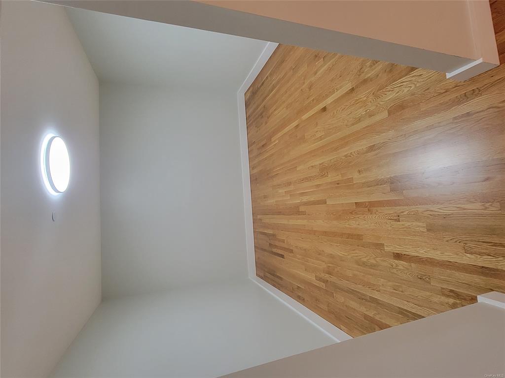 731 Broadway, Unit 4 Valhalla, NY 10595 - Photo 14 of 25 an empty room with wooden floor