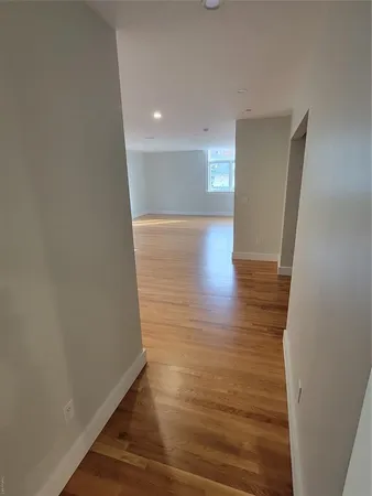 a view of hallway with wooden floor