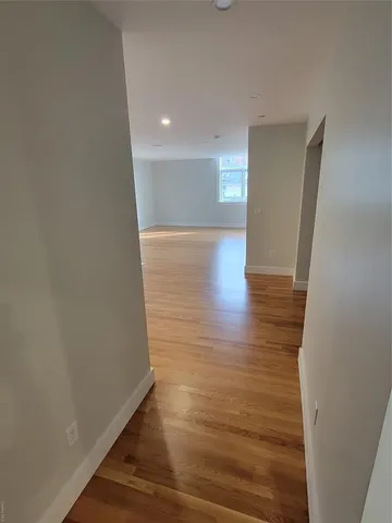 a view of hallway with wooden floor
