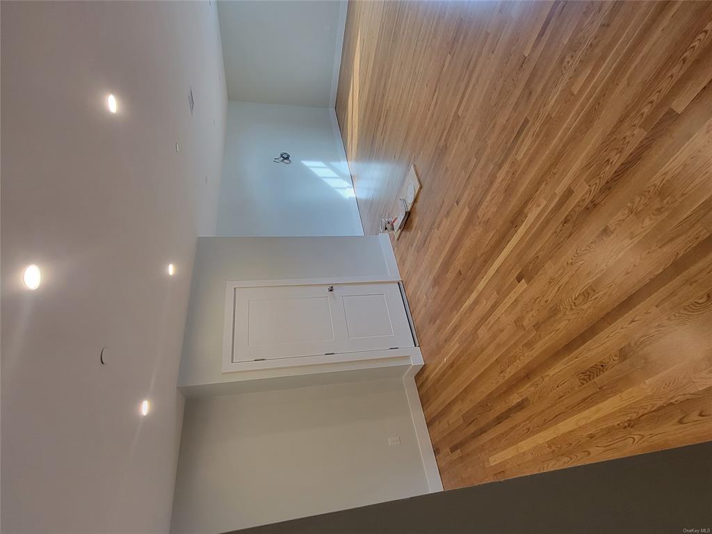 731 Broadway, Unit 4 Valhalla, NY 10595 - Photo 16 of 25 a bedroom with a bed and wooden floor
