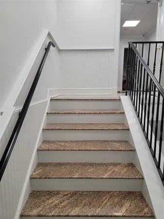 a view of staircase with white walls