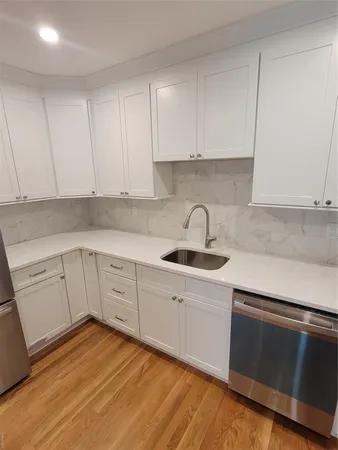 a kitchen with a sink cabinets and stainless steel appliances