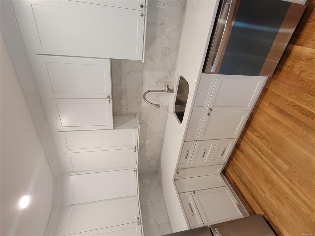 731 Broadway, Unit 4 Valhalla, NY 10595 - Photo 4 of 25 a kitchen with a sink cabinets and stainless steel appliances