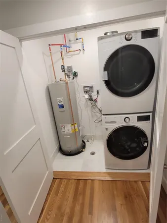 a view of a storage and utility room with washer and dryer