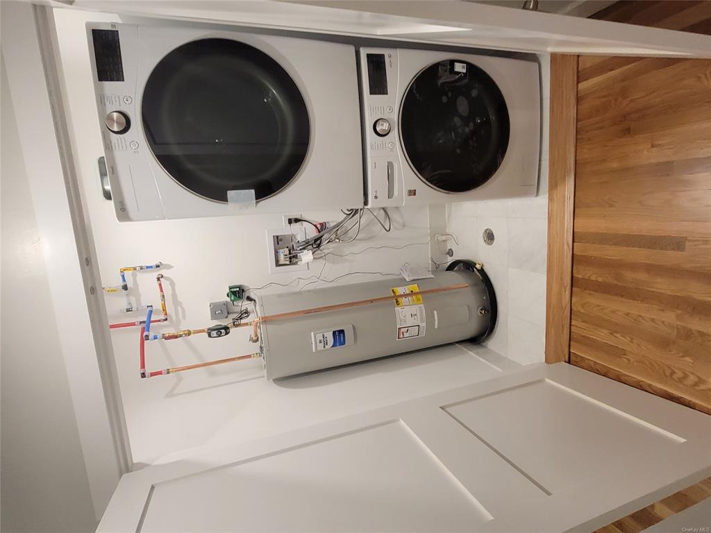 731 Broadway, Unit 4 Valhalla, NY 10595 - Photo 7 of 25 a view of a storage and utility room with washer and dryer