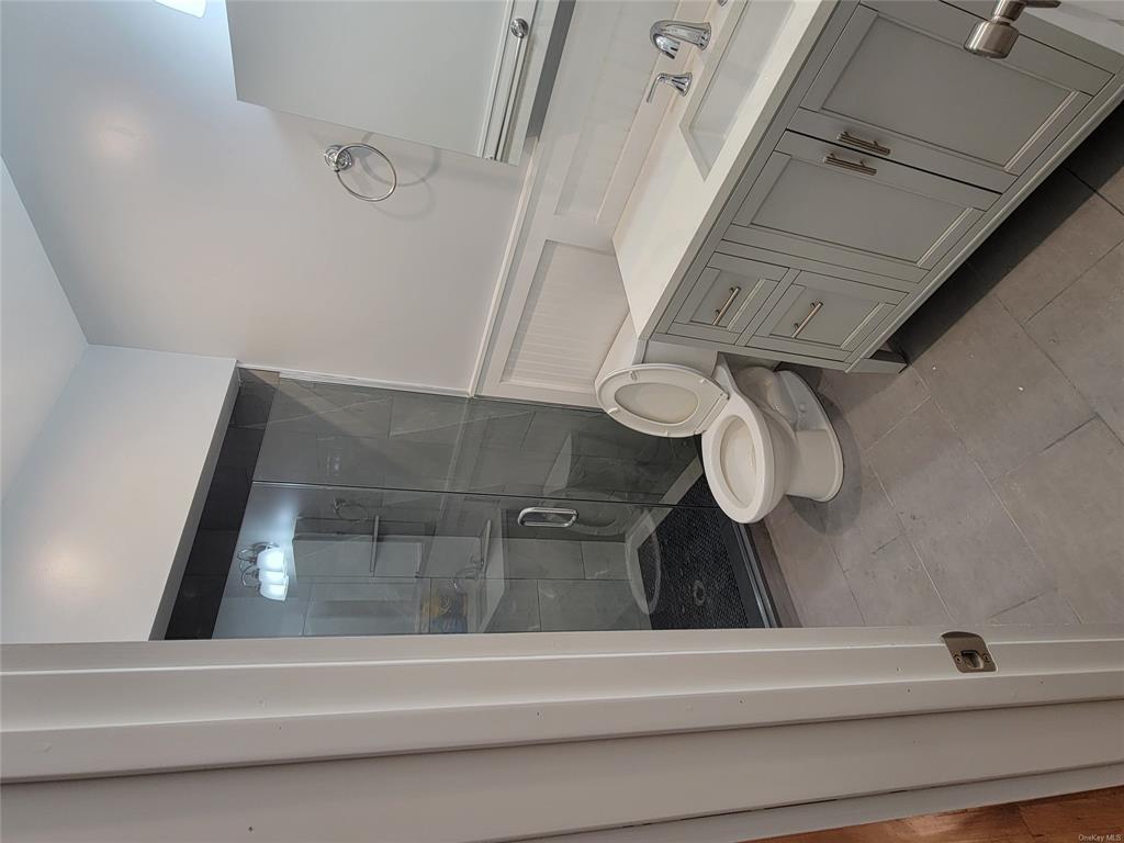 731 Broadway, Unit 4 Valhalla, NY 10595 - Photo 10 of 25 a bathroom with a sink a toilet and shower