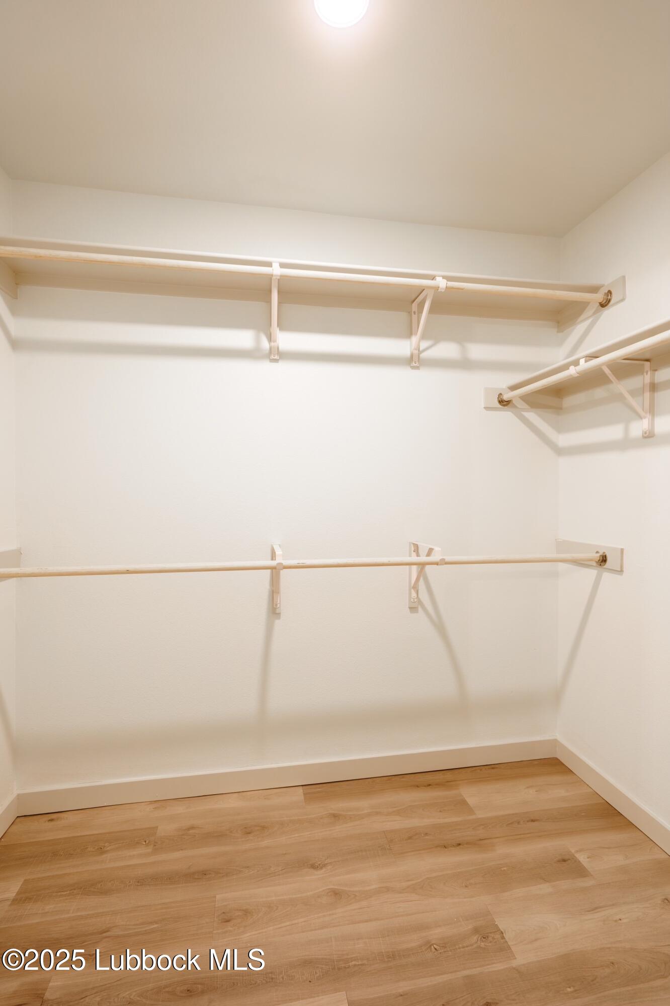 8013 Date Avenue Lubbock, TX 79404 - Photo 8 of 12 a view of a room with an empty walk in closet