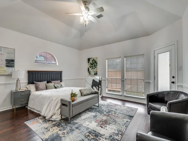 a bedroom with a large bed and a couch