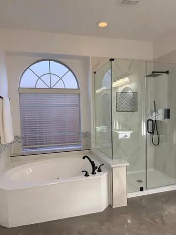 a bathroom with a bathtub and a shower