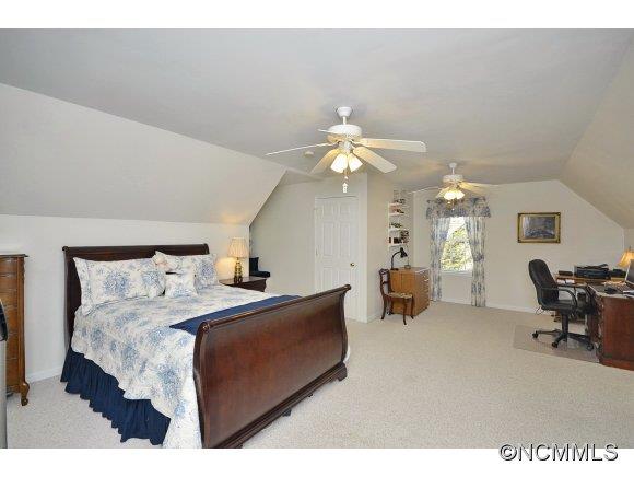 30 Splendor Ridge Waynesville, NC 28785 - Photo 19 of 23 a bedroom with a bed and a chandelier