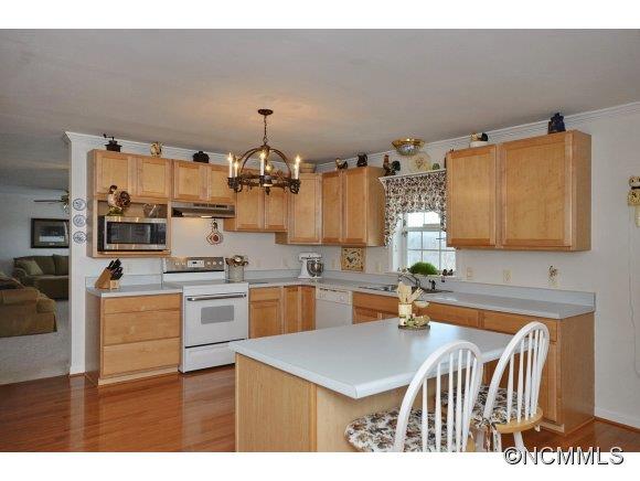 30 Splendor Ridge Waynesville, NC 28785 - Photo 6 of 23 a kitchen that has a lot of cabinets in it and wooden floors