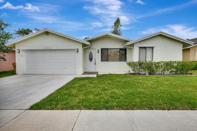 a front view of house with garden