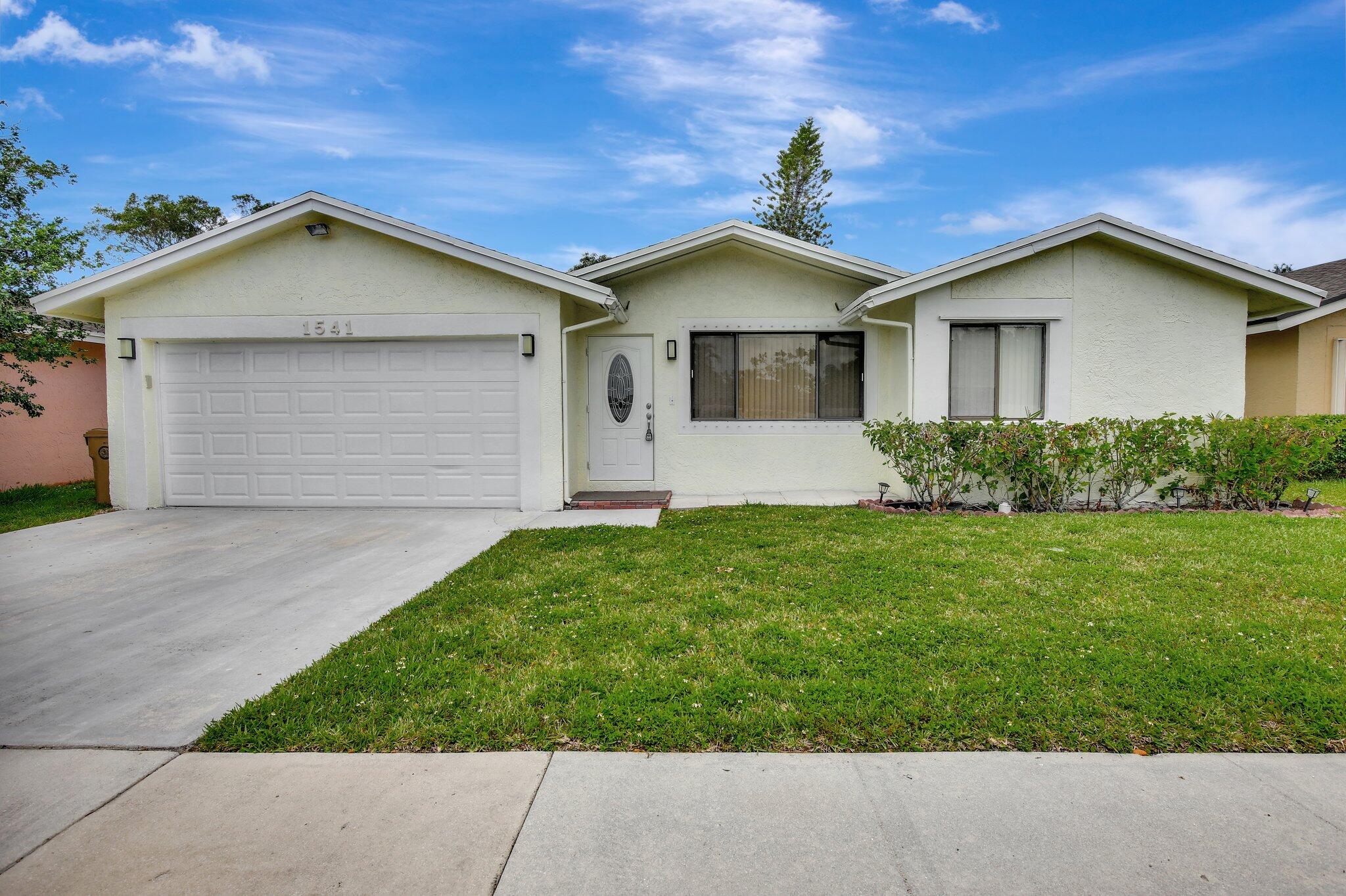 a front view of house with garden