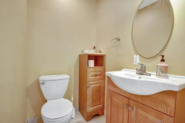 a bathroom with a toilet sink and mirror