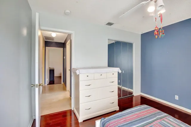 a bedroom with a bed and a dresser