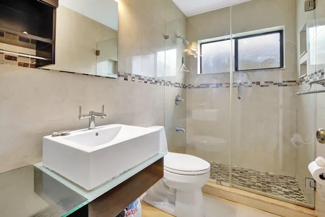 a bedroom with a bed and a night stand