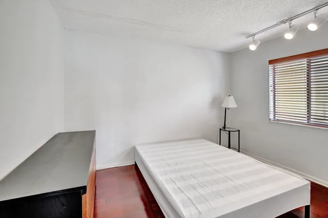 a view of a hallway with wooden floor and glass door