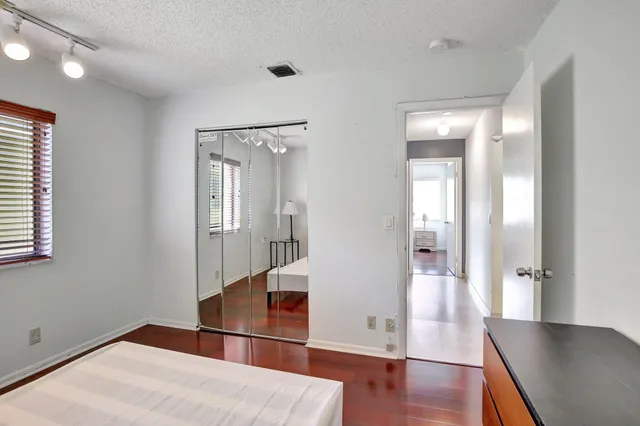 a room with a bed and a dresser