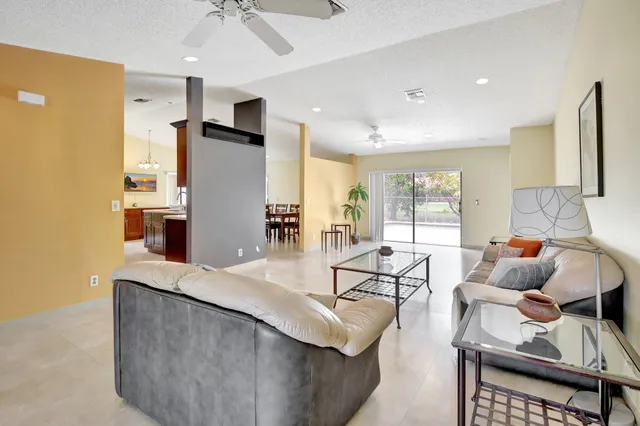 a living room with stainless steel appliances kitchen island granite countertop furniture and a kitchen view
