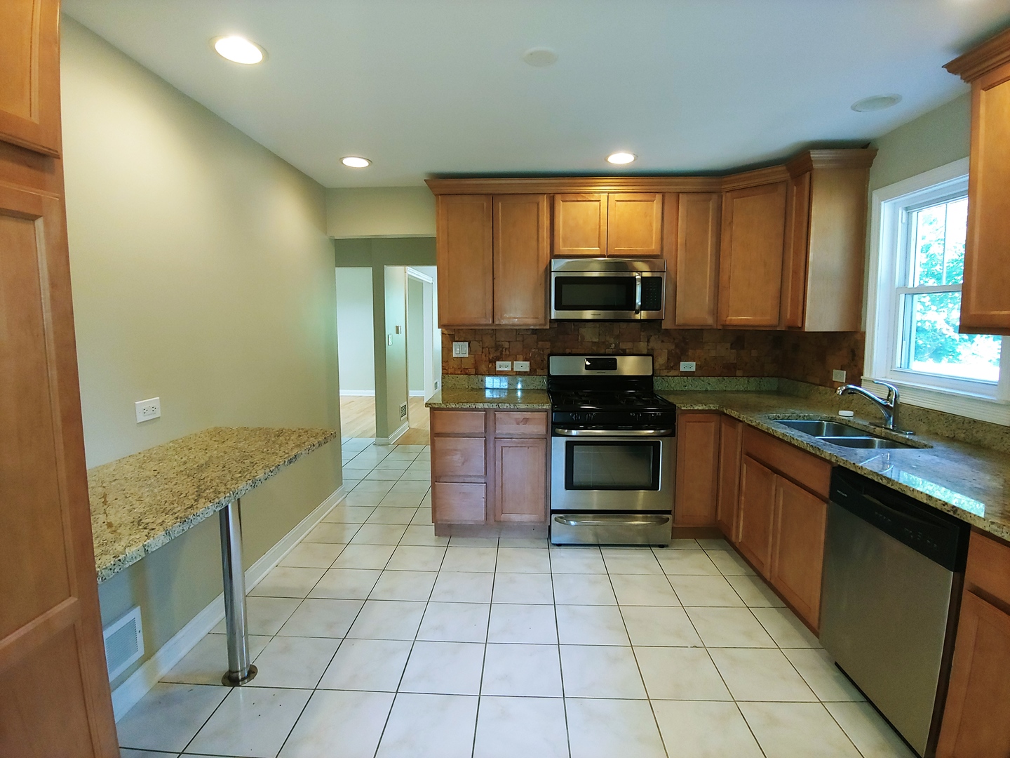 2831 Indian Boundary Road River Grove, IL 60171 - Photo 10 of 19 a large kitchen with granite countertop a stove top oven microwave and cabinets