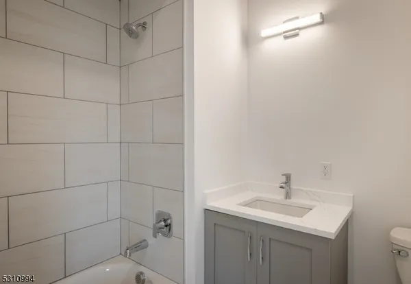 a bathroom with a sink toilet and vanity