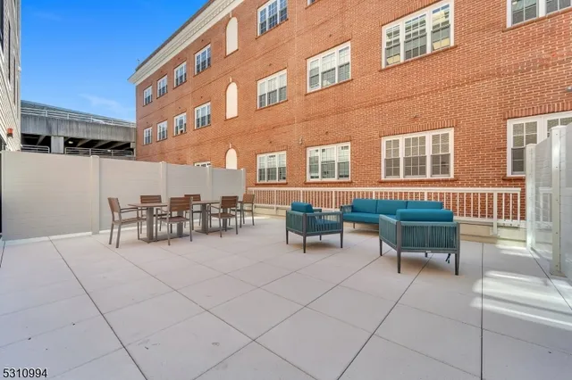 a building outdoor space with patio furniture and potted plants