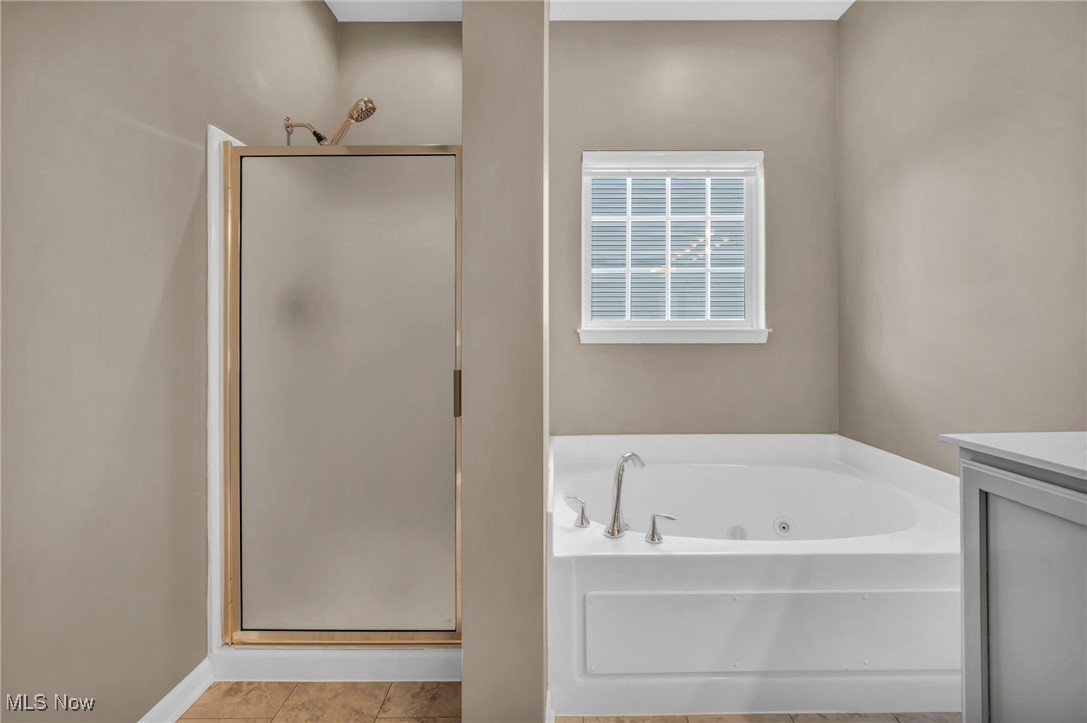143 Stone Ridge Way Berea, OH 44017 - Photo 11 of 47 Full bath with a stall shower, a jetted tub, and vanity
